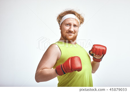 Red haired, bearded, plump man wearing sportswear and red boxing gloves 45879033