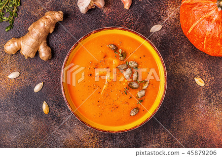 Pumpkin and carrot soup served with seeds. 45879206