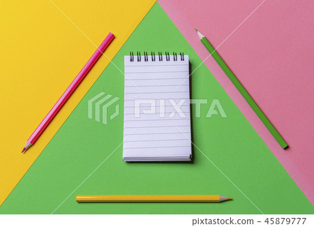 Empty spiral notepad and colorful pencils.  45879777