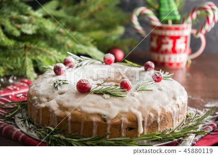 Christmas cake with rosemary on decorative plate. 45880119