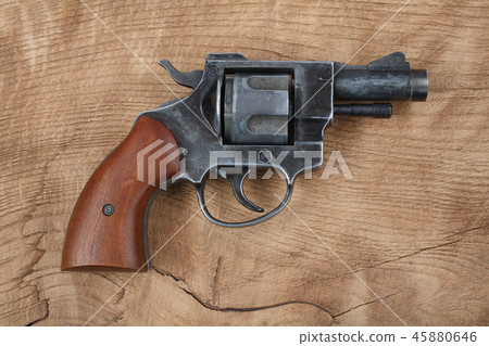 Revolver on the wooden table 45880646