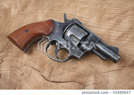 Revolver on the wooden table 45880647