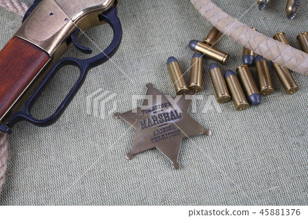 Wild west rifle with ammunition and sheriff badge Wild west rifle with ammunition and sheriff badge 45881376