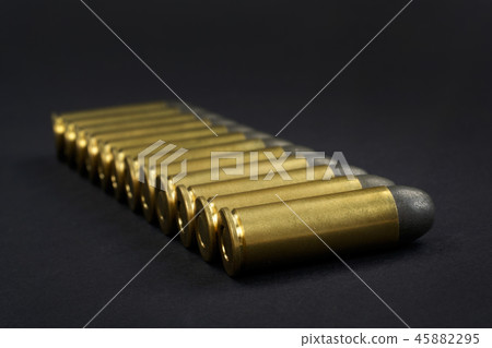 The .45 caliber revolver cartridges on black The .45 caliber revolver cartridges on black 45882295