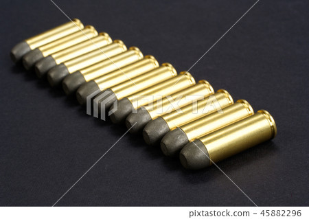 The .45 caliber revolver cartridges on black  45882296