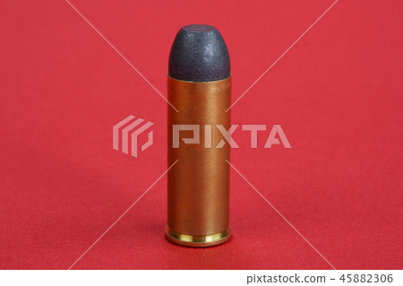 The .45 caliber revolver cartridges on red The .45 caliber revolver cartridges on red 45882306