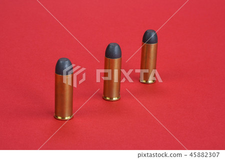 The .45 caliber revolver cartridges on red  45882307