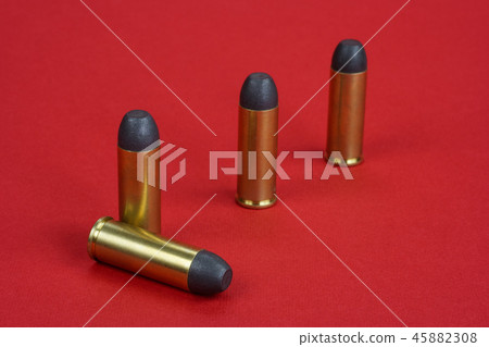 The .45 caliber revolver cartridges on red  45882308