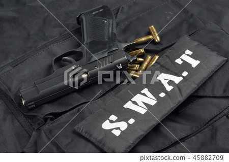 handgun on SWAT black uniform background 45882709
