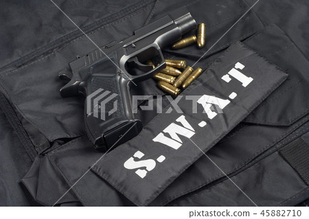 handgun on SWAT black uniform background 45882710