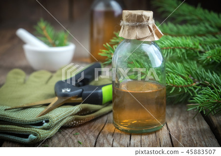 Pine essential oil in a glass bottle. Pine essential oil in a glass bottle. 45883507