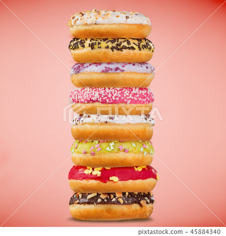Stack of assorted donuts on pastel background. Stack of assorted donuts on pastel background. 45884340