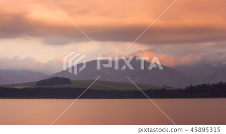 Long Exposure Shot. Lake, Mountains and Cloudy Sky Long Exposure Shot. Lake, Mountains and Cloudy Sky 45895315