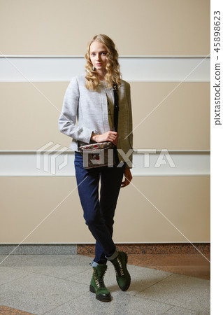Cute student girl in jacket, jeans and boots  45898623
