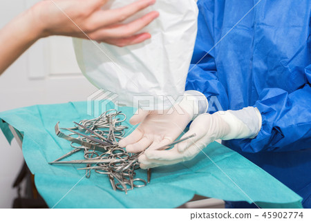 Scrub nurse preparing medical instruments Scrub nurse preparing medical instruments 45902774
