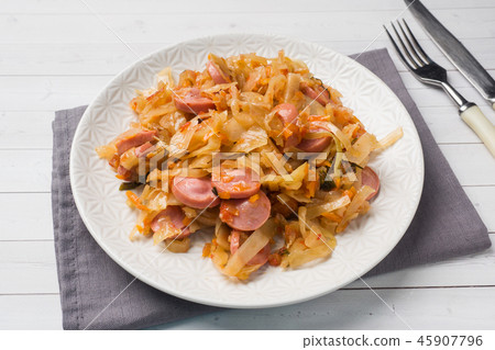 Stewed cabbage with sausages in a plate Stewed cabbage with sausages in a plate 45907796
