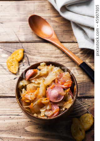 Stewed cabbage with sausages in a plate  45907805