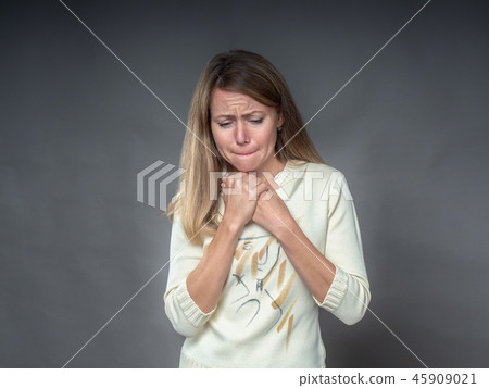 Woman with hands on his chest sorrowfully with Woman with hands on his chest sorrowfully with 45909021