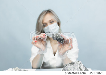 The girl laboratory technician examines samples 45909823
