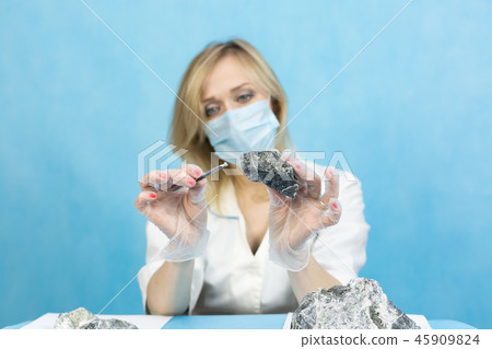 The girl laboratory technician examines samples 45909824