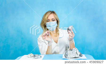 The girl laboratory technician examines samples The girl laboratory technician examines samples 45909827