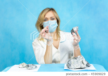 The girl laboratory technician examines samples The girl laboratory technician examines samples 45909829