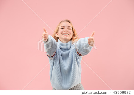 The happy business woman standing and smiling against pink background. The happy business woman standing and smiling against pink background. 45909982