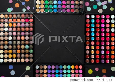 Makeup eyeshadow palettes with colorful confetti on black background Makeup eyeshadow palettes with colorful confetti on black background 45910045