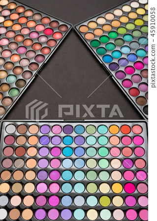 Above view of eyeshadow palettes as a colorful make-up background Above view of eyeshadow palettes as a colorful make-up background 45910058