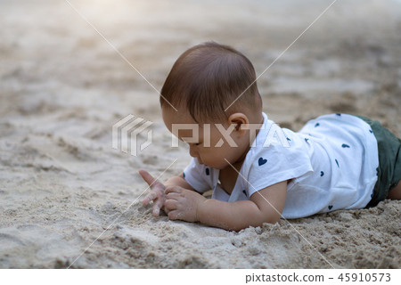Asian toddler baby thai girl playing with sand 45910573