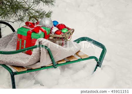 sledges, blanket, basket with toys and gift boxes 45911151