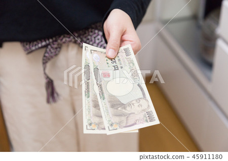 Woman passing money 45911180