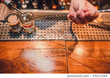 Bartender making shots on black bar with reflection. 45911569