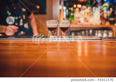 Bartender making shots on black bar with reflection. 45911576