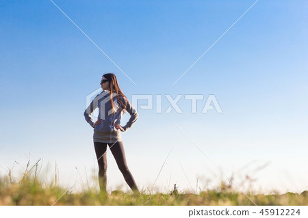woman standing against the sky. woman standing against the sky. 45912224
