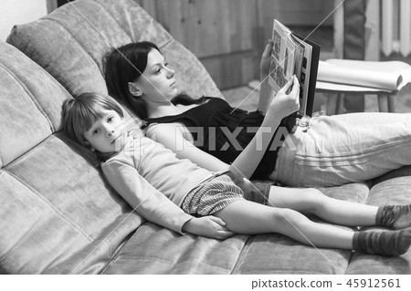 mother and her son read book 45912561