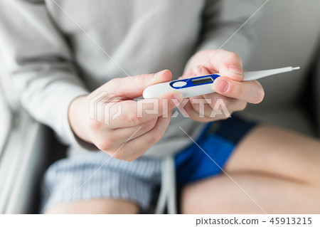 Child boy thermometer measures temperature. 45913215