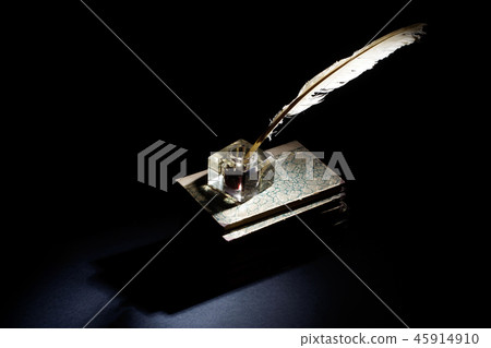 background with old ink bottle, books, and quill 45914910