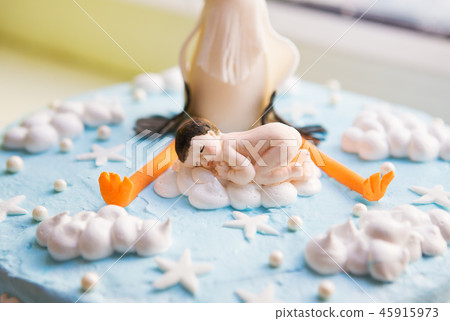 bright blue baptismal cake with baby and stork, close-up 45915973
