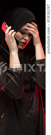 Portrait of beautiful serious scared frightened frustrated young muslim woman wearing black hijab Portrait of beautiful serious scared frightened frustrated young muslim woman wearing black hijab 45916297