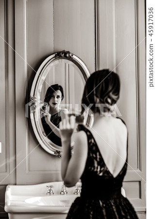 young woman with comb near mirror young woman with comb near mirror 45917036