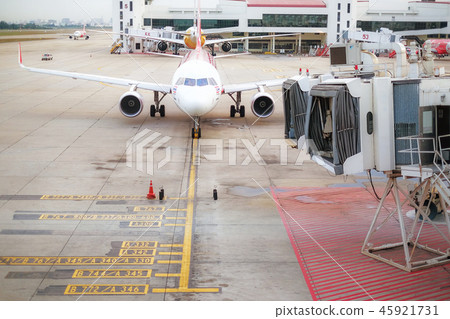 Aircraft docked to a jetway at the airport 45921731