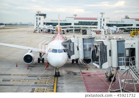 Aircraft docked to a jetway at the airport 45921732