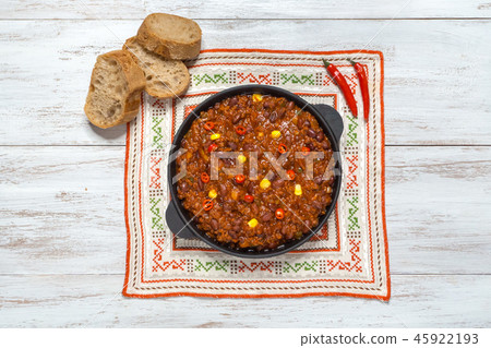 Pan of Texas chili on white wooden background. 45922193