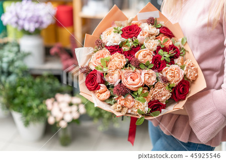 European floral shop. Bouquet of beautiful Mixed flowers in woman hand. Excellent garden flowers in European floral shop. Bouquet of beautiful Mixed flowers in woman hand. Excellent garden flowers in 45925546