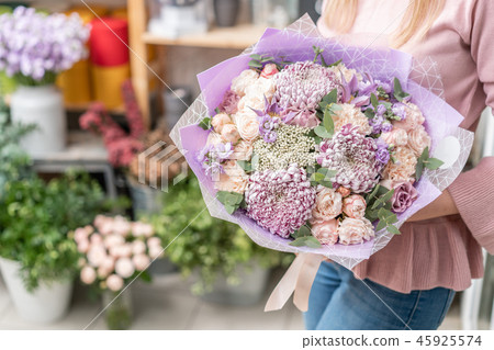 European floral shop. Bouquet of beautiful Mixed flowers in woman hand. Excellent garden flowers in European floral shop. Bouquet of beautiful Mixed flowers in woman hand. Excellent garden flowers in 45925574