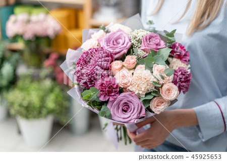 European floral shop. Bouquet of beautiful Mixed flowers in woman hand. Excellent garden flowers in European floral shop. Bouquet of beautiful Mixed flowers in woman hand. Excellent garden flowers in 45925653