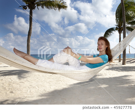 beautiful young woman in a hammock on the beach on beautiful young woman in a hammock on the beach on 45927778