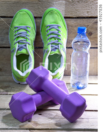 Sports sneakers, dumbbells, drinking water on a wo Sports sneakers, dumbbells, drinking water on a wo 45927836