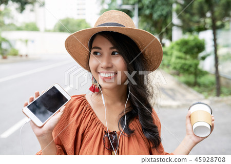 Young woman with smartphone and coffee cup Young woman with smartphone and coffee cup 45928708